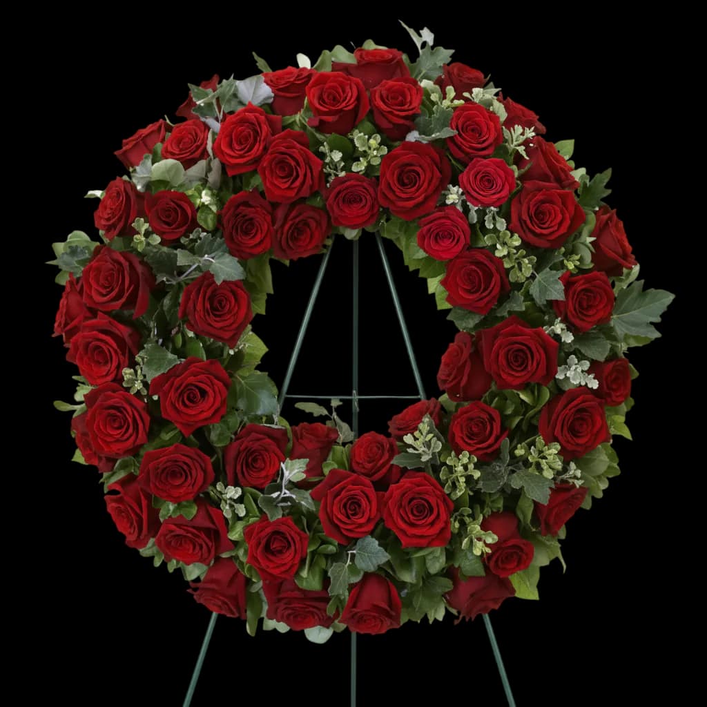 Coroană funerară rotundă clasică din trandafiri roșii pe stativ